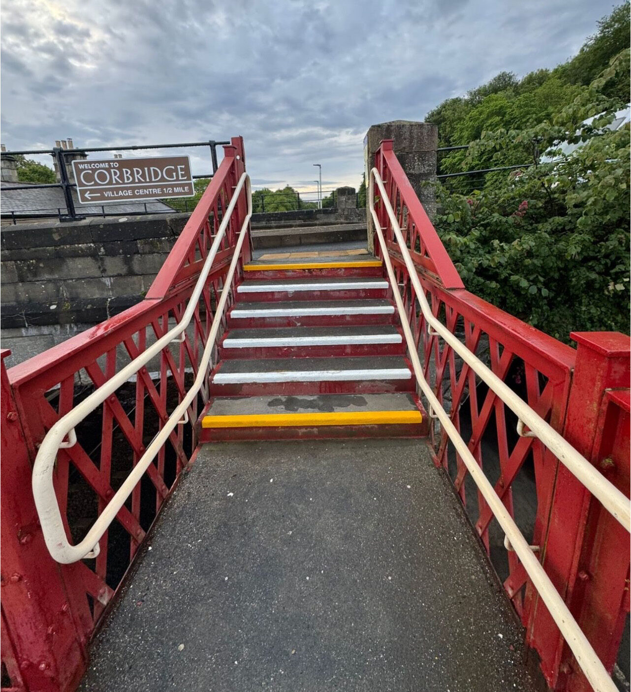 High-visibility anti-slip step-edge markings on the station staircase