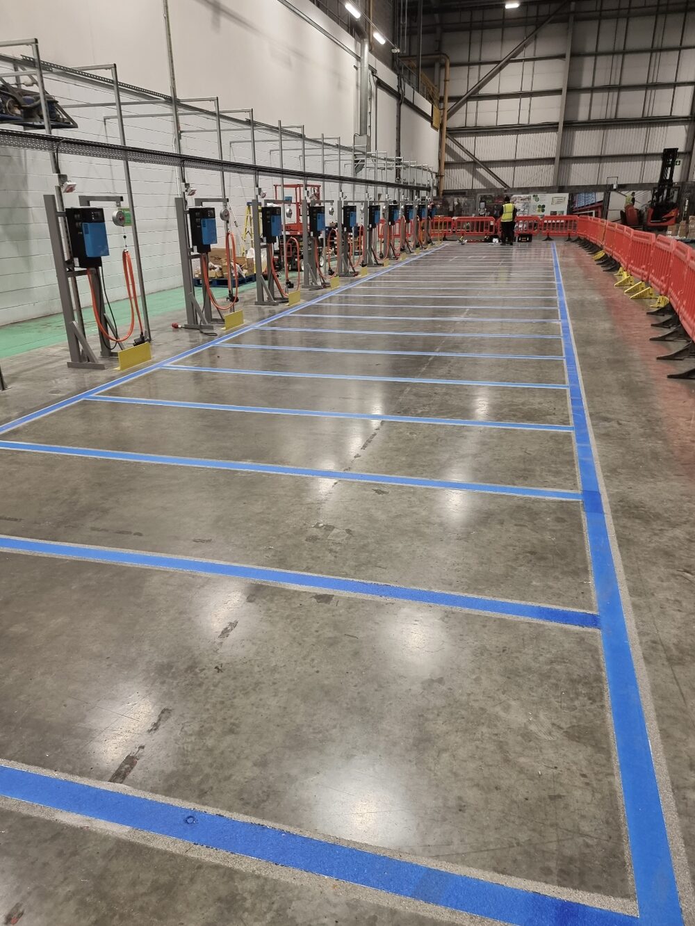 UV-cured blue lane markings beside the charging bays